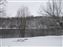 Looking across the river with snow on the ground.