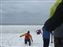This year's Polar Bear Plunge is over. The Dive Rescue Team is coming out of the water. Note now they are falling through the frozen crust too.